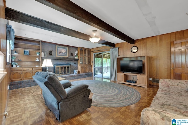 5420 Pine St, Sylvan Springs, AL 35118 - living room featuring wooden walls, a brick fireplace, and beam ceiling