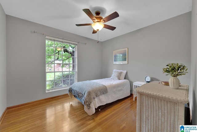 5420 Pine St, Sylvan Springs, AL 35118 - bedroom featuring light wood-style floors, a ceiling fan, and baseboards