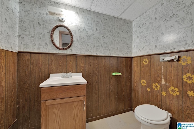 5420 Pine St, Sylvan Springs, AL 35118 - bathroom with vanity, wainscoting, wallpapered walls, toilet, and wood walls