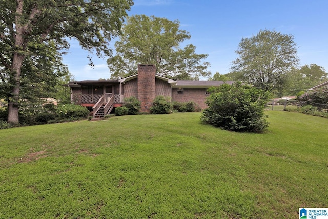 5420 Pine St, Sylvan Springs, AL 35118 - view of green lawn with a sunroom and stairway