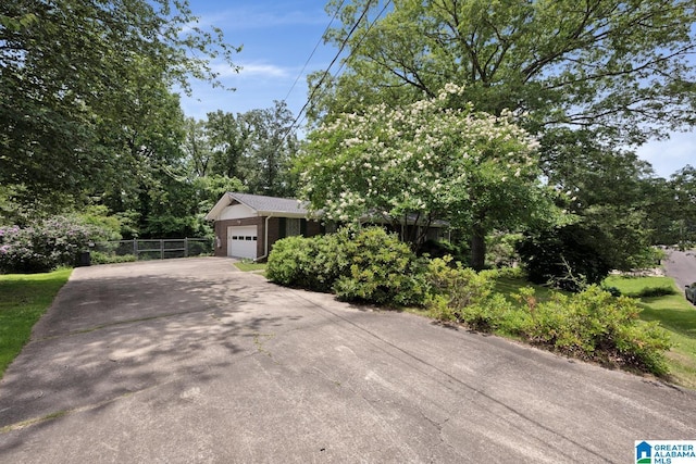 5420 Pine St, Sylvan Springs, AL 35118 - obstructed view of property featuring a garage and driveway
