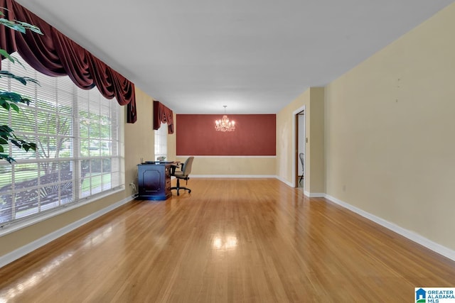 5420 Pine St, Sylvan Springs, AL 35118 - unfurnished living room with light wood-type flooring, a chandelier, and baseboards