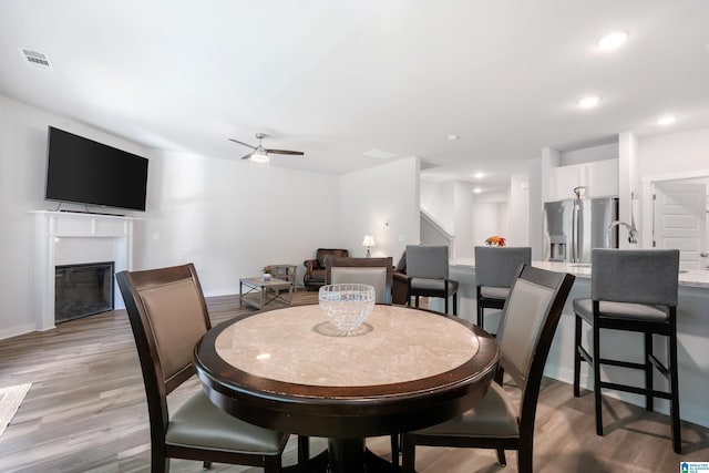119 Polo Downs, Chelsea, AL 35043 - dining space featuring light wood finished floors, ceiling fan, a glass covered fireplace, baseboards, and recessed lighting
