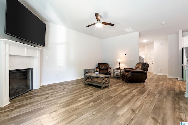 119 Polo Downs, Chelsea, AL 35043 - living area with a ceiling fan, light wood finished floors, a glass covered fireplace, and baseboards