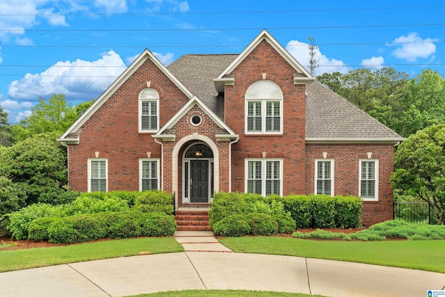 5265 Lake Crest Cir, Hoover, AL 35226 - traditional-style home featuring brick siding, a front lawn, and roof with shingles