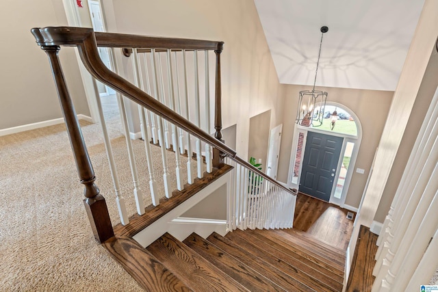 5265 Lake Crest Cir, Hoover, AL 35226 - entryway featuring stairs, a chandelier, a towering ceiling, baseboards, and wood finished floors