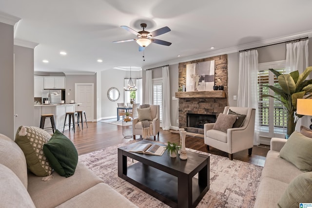 5265 Lake Crest Cir, Hoover, AL 35226 - living room featuring ornamental molding, light wood-style floors, ceiling fan, recessed lighting, and a stone fireplace
