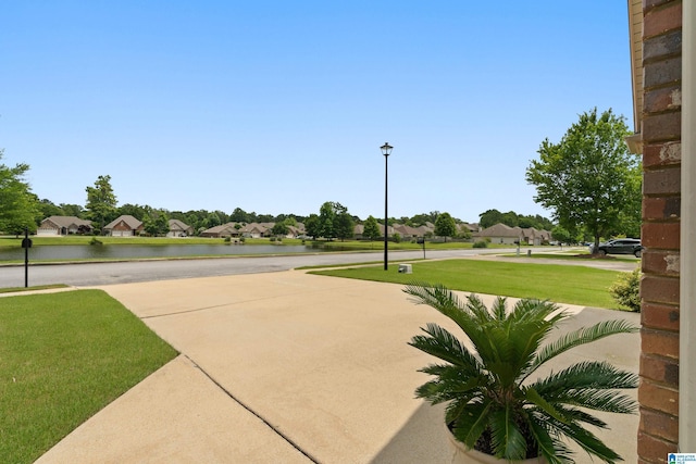 3096 Hidden Forest Cv, Montevallo, AL 35115 - view of concrete road with a water view, street lights, and a residential view