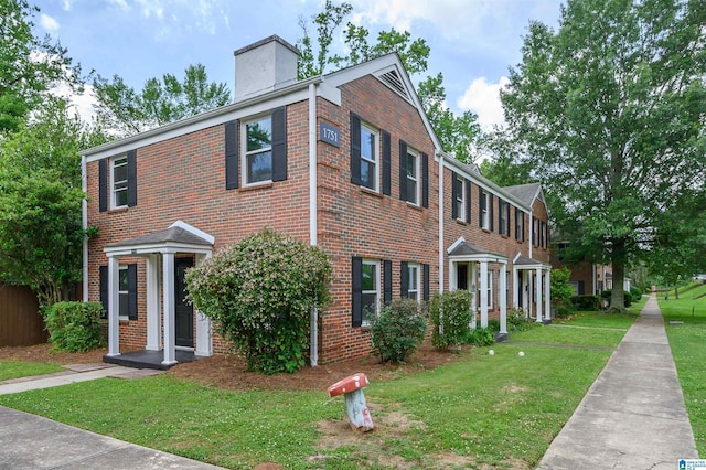1751 Valley Ave Unit D, Homewood, AL 35209 - view of front of property featuring brick siding, a chimney, and a front lawn