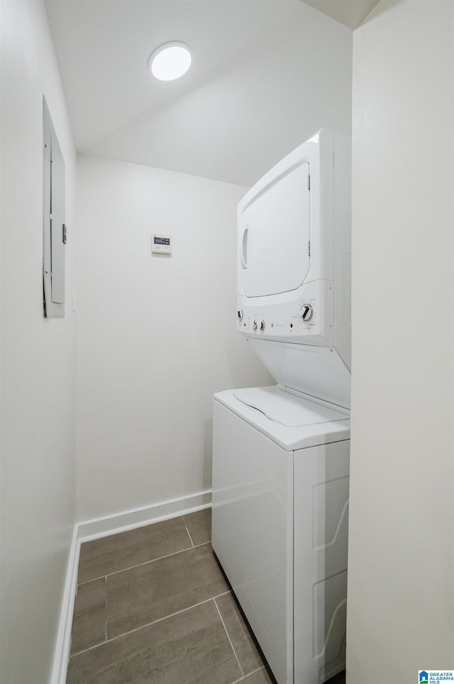 1751 Valley Ave Unit D, Homewood, AL 35209 - washroom featuring estacked washer and dryer, electric panel, baseboards, and tile patterned flooring