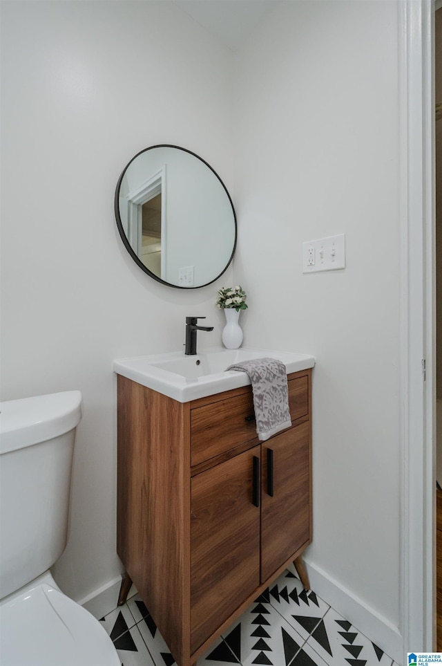 1751 Valley Ave Unit D, Homewood, AL 35209 - bathroom featuring vanity, baseboards, and toilet