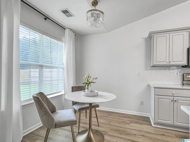 156 Brook Highland Cv, Birmingham, AL 35242 - dining space with plenty of natural light, light wood finished floors, baseboards, and a chandelier