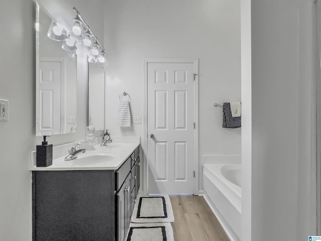156 Brook Highland Cv, Birmingham, AL 35242 - bathroom featuring double vanity, wood finished floors, and a garden tub