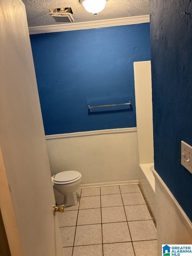 261 Ebenezer Rd, Odenville, AL 35120 - full bathroom featuring toilet, a textured ceiling, tile patterned floors, a bathtub, and ornamental molding