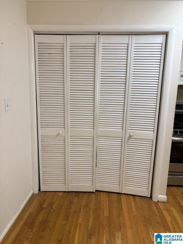 261 Ebenezer Rd, Odenville, AL 35120 - detailed view of stainless steel range with electric cooktop, wood finished floors, and baseboards