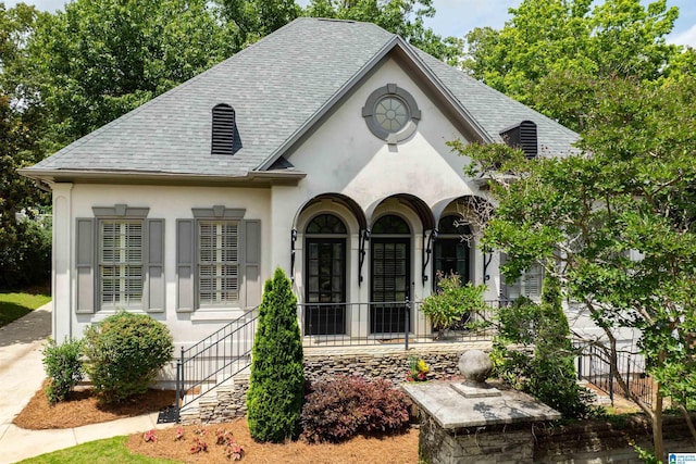 2300 Ridge Trl, Birmingham, AL 35242 - view of front facade with stucco siding, roof with shingles, a porch, and stairway