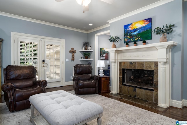 2300 Ridge Trl, Birmingham, AL 35242 - living room featuring a ceiling fan, wood finished floors, baseboards, a tiled fireplace, and crown molding