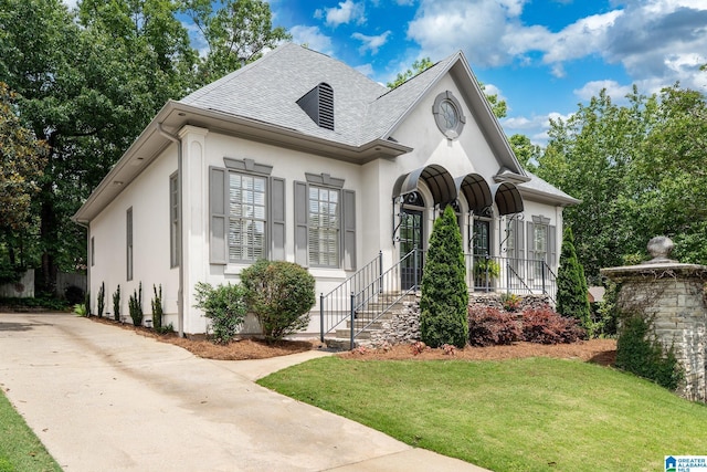 2300 Ridge Trl, Birmingham, AL 35242 - french country inspired facade with a shingled roof, a front yard, stucco siding, and driveway