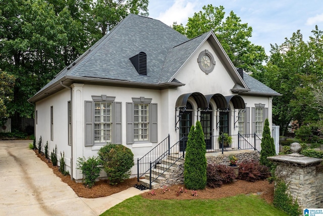 2300 Ridge Trl, Birmingham, AL 35242 - french country inspired facade featuring stucco siding, a shingled roof, and a porch
