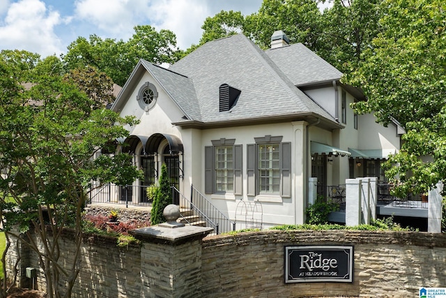 2300 Ridge Trl, Birmingham, AL 35242 - french country inspired facade featuring stucco siding, roof with shingles, and a chimney