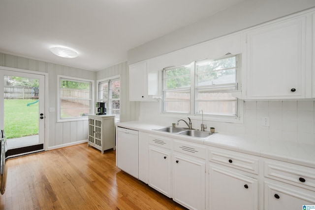 1718 Windsor Blvd, Homewood, AL 35209 - kitchen with a sink, white dishwasher, light wood-type flooring, and decorative backsplash