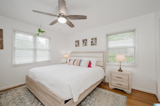 1718 Windsor Blvd, Homewood, AL 35209 - bedroom featuring multiple windows, baseboards, wood finished floors, and a ceiling fan