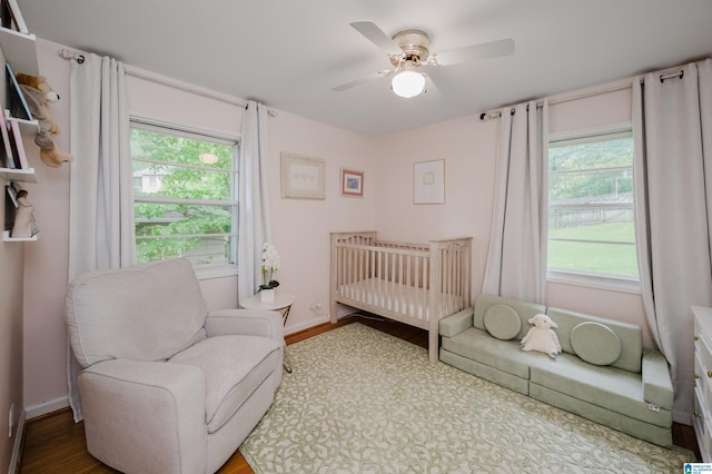 1718 Windsor Blvd, Homewood, AL 35209 - bedroom with wood finished floors, a crib, a ceiling fan, and baseboards