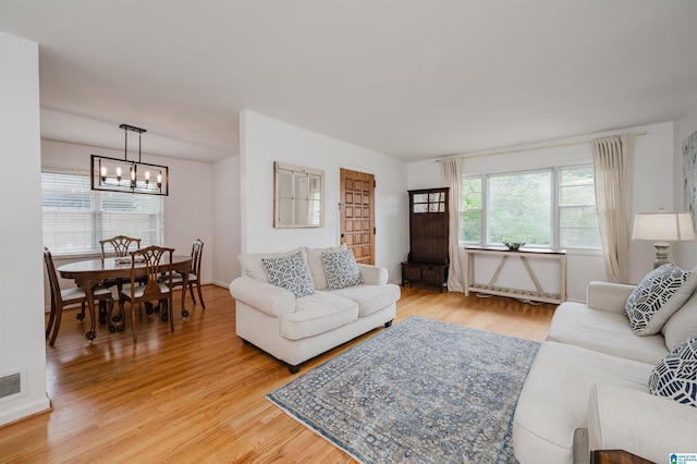 1718 Windsor Blvd, Homewood, AL 35209 - living room with a chandelier and light wood-style floors