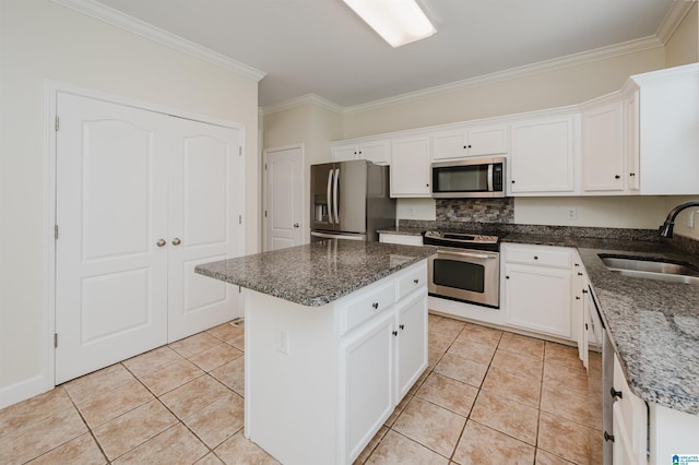 822 Boulder Ridge Cir, Hoover, AL 35244 - kitchen featuring stainless steel appliances, a sink, ornamental molding, white cabinets, and light tile patterned flooring