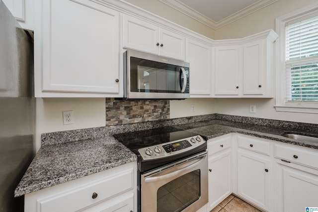 822 Boulder Ridge Cir, Hoover, AL 35244 - kitchen with appliances with stainless steel finishes, white cabinetry, dark stone countertops, crown molding, and light tile patterned flooring