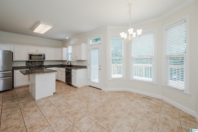 822 Boulder Ridge Cir, Hoover, AL 35244 - kitchen with appliances with stainless steel finishes, crown molding, a chandelier, light tile patterned floors, and white cabinetry