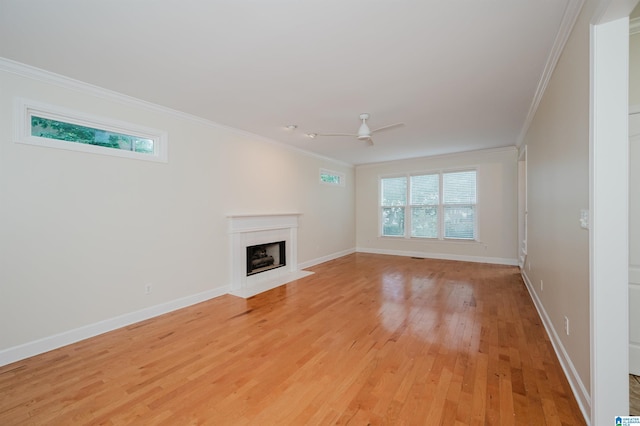 822 Boulder Ridge Cir, Hoover, AL 35244 - unfurnished living room featuring crown molding, a fireplace with flush hearth, light wood finished floors, and baseboards