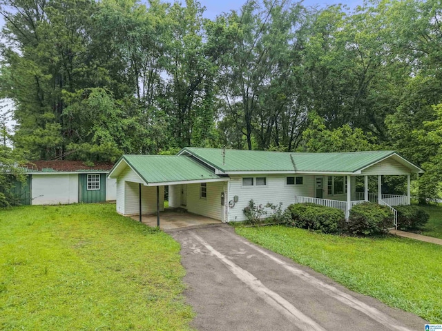 315 3rd Ave, Odenville, AL 35120 - ranch-style house featuring driveway, a front yard, a porch, and an attached carport