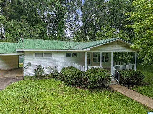 315 3rd Ave, Odenville, AL 35120 - view of front facade with a front lawn, a porch, an attached carport, asphalt driveway, and metal roof