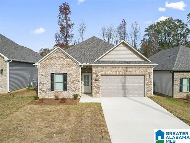 3785 Seaside Sparrow Cir, Bessemer, AL 35022 - view of front facade featuring a garage, concrete driveway, brick siding, and central air condition unit