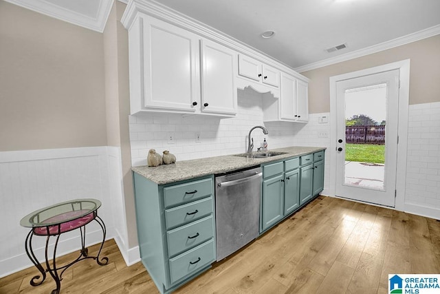 123 Whitestone Trl, Calera, AL 35040 - kitchen featuring dishwasher, a sink, white cabinets, crown molding, and a wainscoted wall