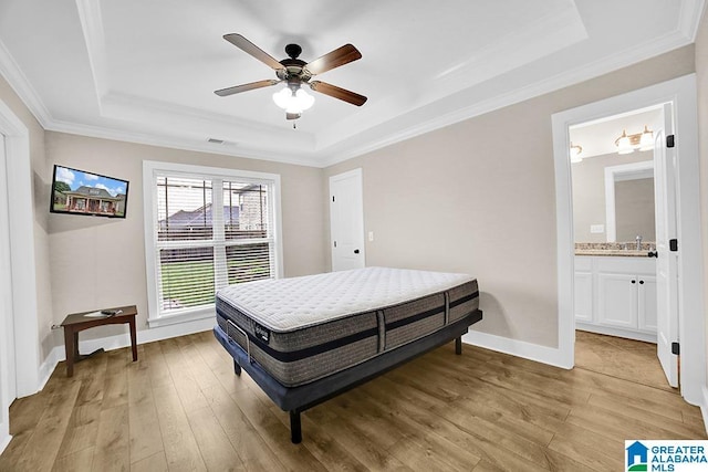 123 Whitestone Trl, Calera, AL 35040 - bedroom featuring a tray ceiling, light wood-style flooring, crown molding, baseboards, and a sink