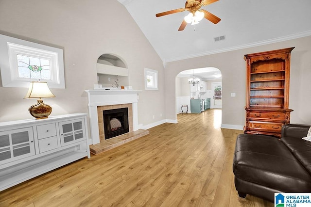 123 Whitestone Trl, Calera, AL 35040 - living area with arched walkways, a ceiling fan, a chandelier, ornamental molding, and wood finished floors