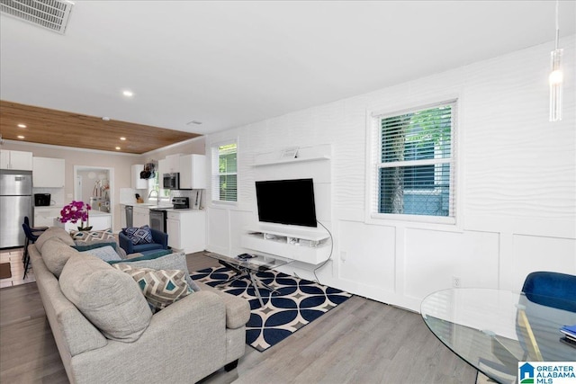 4808 S 3rd Ave, Birmingham, AL 35222 - living room with wood finished floors, recessed lighting, and a decorative wall