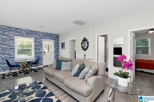 4808 S 3rd Ave, Birmingham, AL 35222 - living room featuring light wood finished floors, wallpapered walls, and a ceiling fan