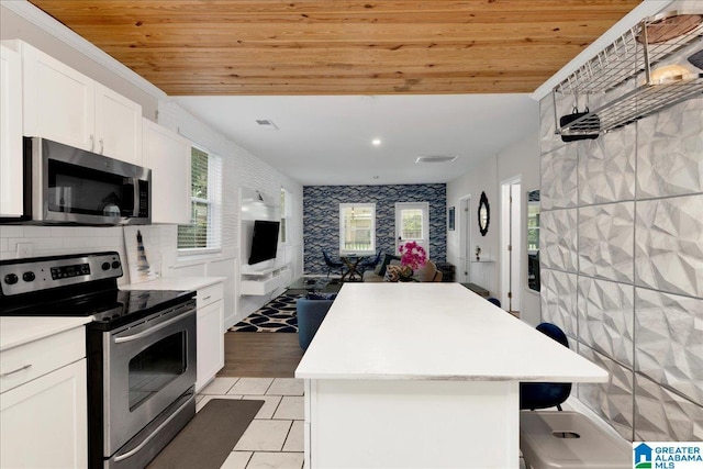 4808 S 3rd Ave, Birmingham, AL 35222 - kitchen with stainless steel appliances, wood ceiling, a center island, open floor plan, and light countertops