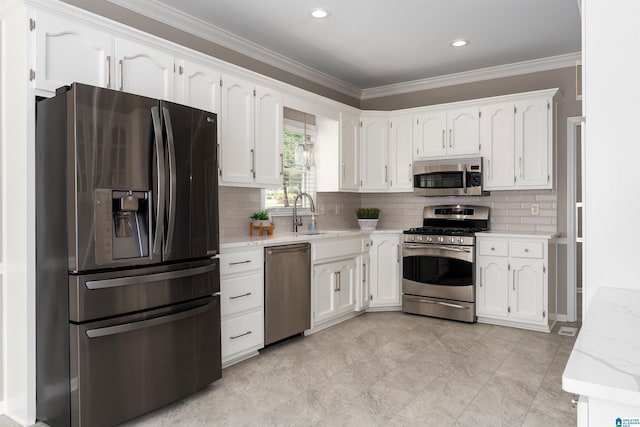 100 Redwood Dr, Trussville, AL 35173 - kitchen featuring stainless steel appliances, white cabinetry, ornamental molding, decorative backsplash, and light stone countertops