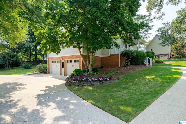 100 Redwood Dr, Trussville, AL 35173 - view of property hidden behind natural elements featuring brick siding, an attached garage, concrete driveway, and a front lawn