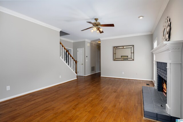 100 Redwood Dr, Trussville, AL 35173 - unfurnished living room featuring a fireplace, stairway, ceiling fan, wood-type flooring, and ornamental molding