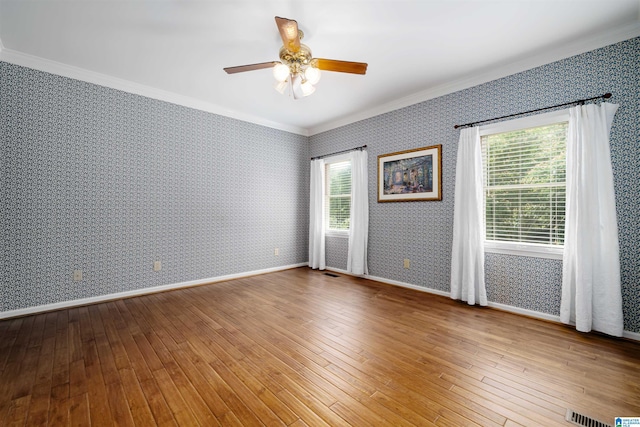 100 Redwood Dr, Trussville, AL 35173 - empty room with crown molding, wallpapered walls, a ceiling fan, and wood-type flooring