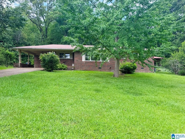 1315 Gloria Ln, Weaver, AL 36277 - view of front of home featuring driveway, a front yard, an attached carport, and brick siding