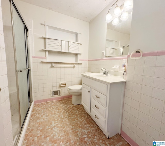 1315 Gloria Ln, Weaver, AL 36277 - full bath featuring tile walls, vanity, a shower stall, toilet, and tile patterned flooring