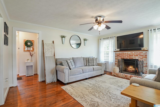1693 4th Ave N, Clanton, AL 35045 - living area with a ceiling fan, dark wood-type flooring, a fireplace, crown molding, and baseboards