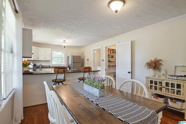 1693 4th Ave N, Clanton, AL 35045 - dining area with a textured ceiling, crown molding, and dark wood-style floors