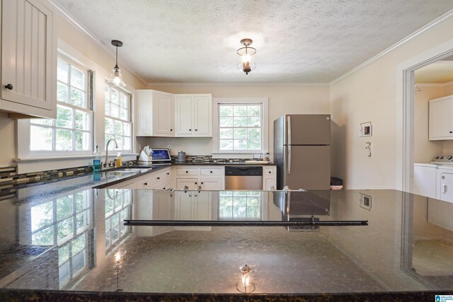 1693 4th Ave N, Clanton, AL 35045 - kitchen with stainless steel appliances, a sink, washing machine and dryer, white cabinetry, and ornamental molding